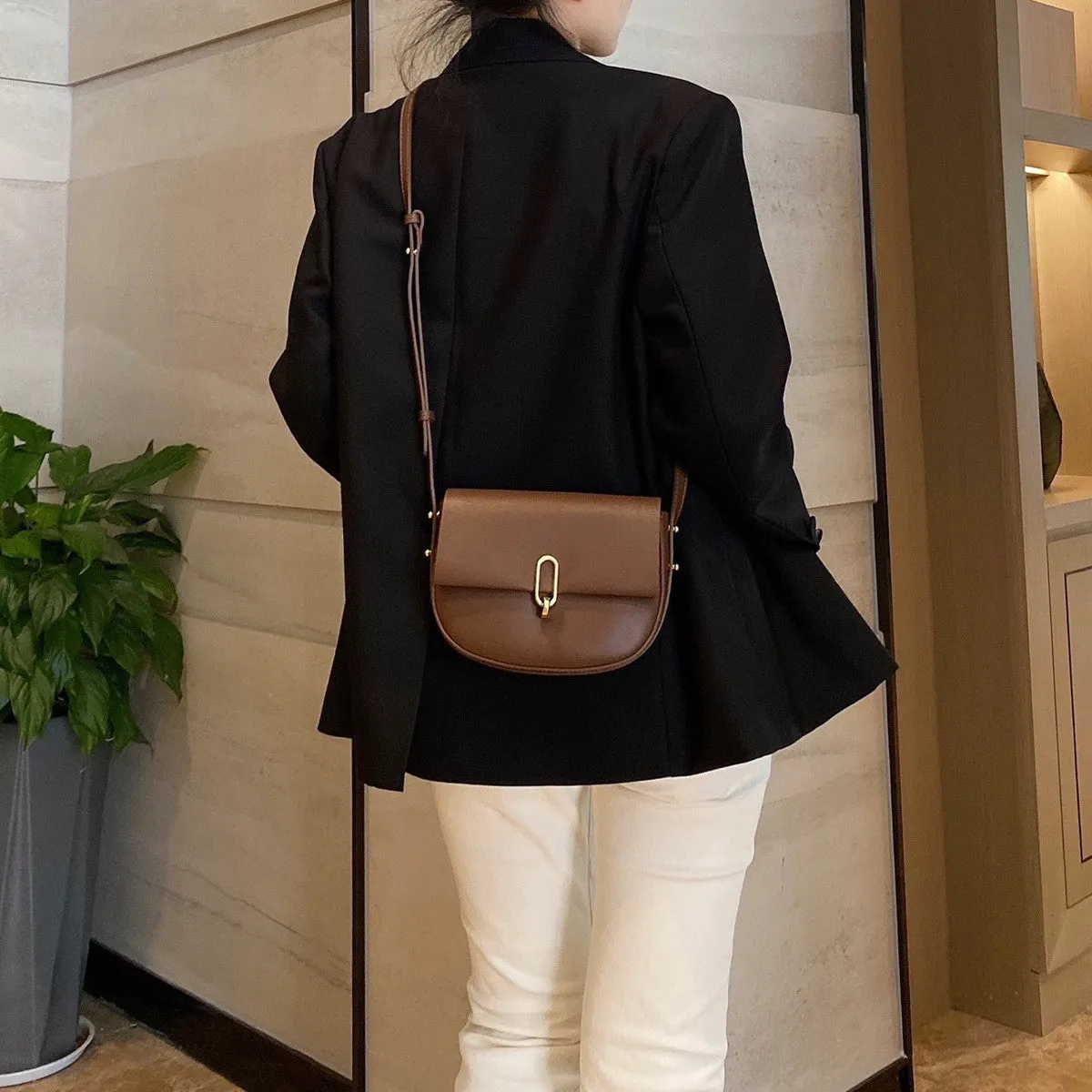 Modern Elegance: Niche Lock Cowhide Saddle Bag with Advanced Design Sense